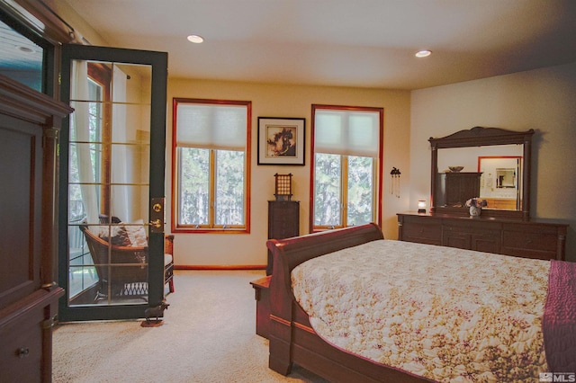 bedroom with carpet floors and multiple windows