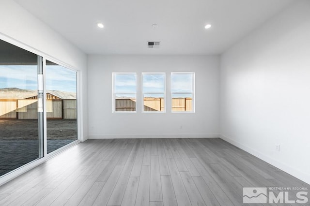 empty room featuring hardwood / wood-style flooring and a wealth of natural light