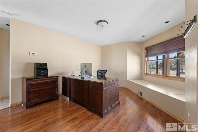 office space with dark hardwood / wood-style flooring