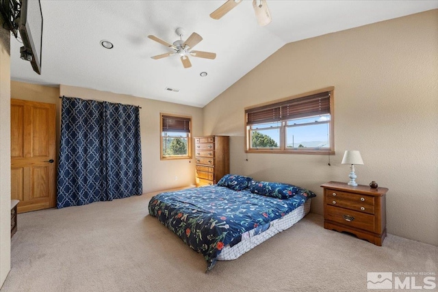 carpeted bedroom featuring vaulted ceiling and ceiling fan