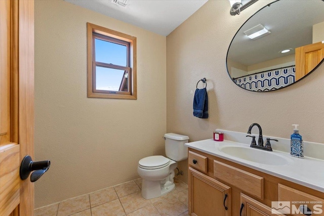 bathroom featuring walk in shower, vanity, toilet, and tile patterned floors