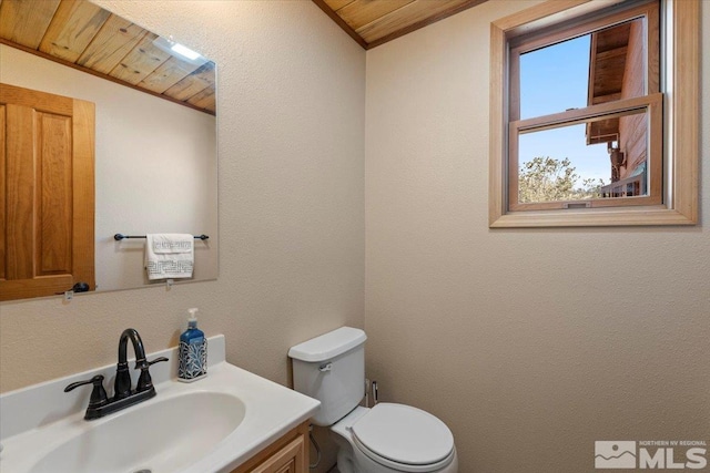 bathroom with wood ceiling, vanity, and toilet