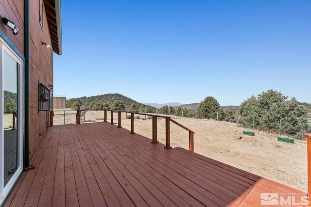 wooden deck featuring a mountain view