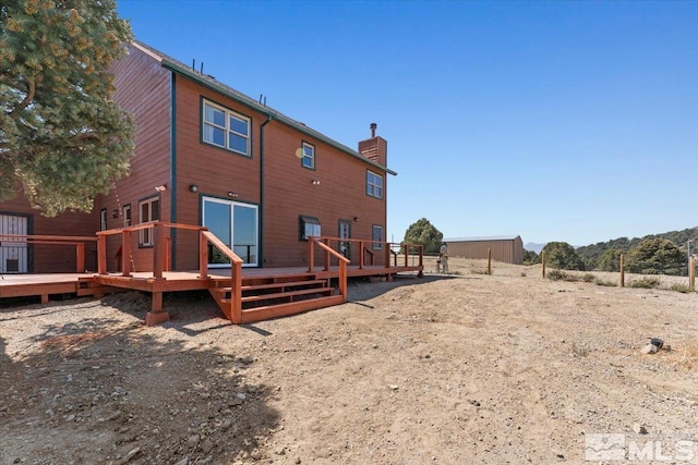 back of house featuring a deck