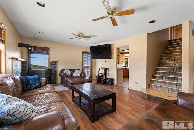 living room featuring ceiling fan and hardwood / wood-style floors