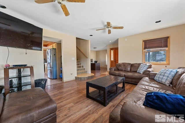 living room featuring ceiling fan and hardwood / wood-style floors