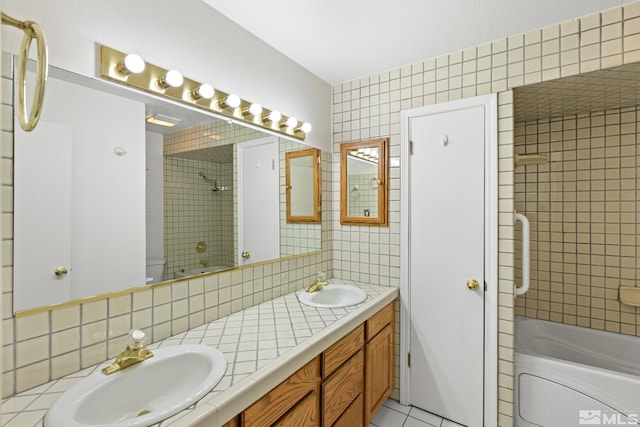 bathroom featuring vanity, tiled shower / bath combo, and tile patterned floors