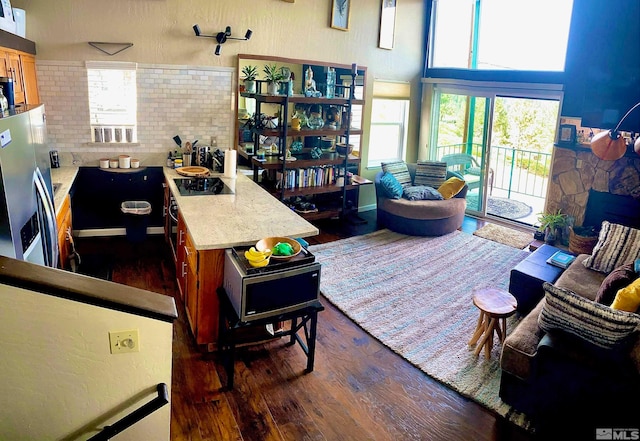 living room with dark hardwood / wood-style flooring and a high ceiling