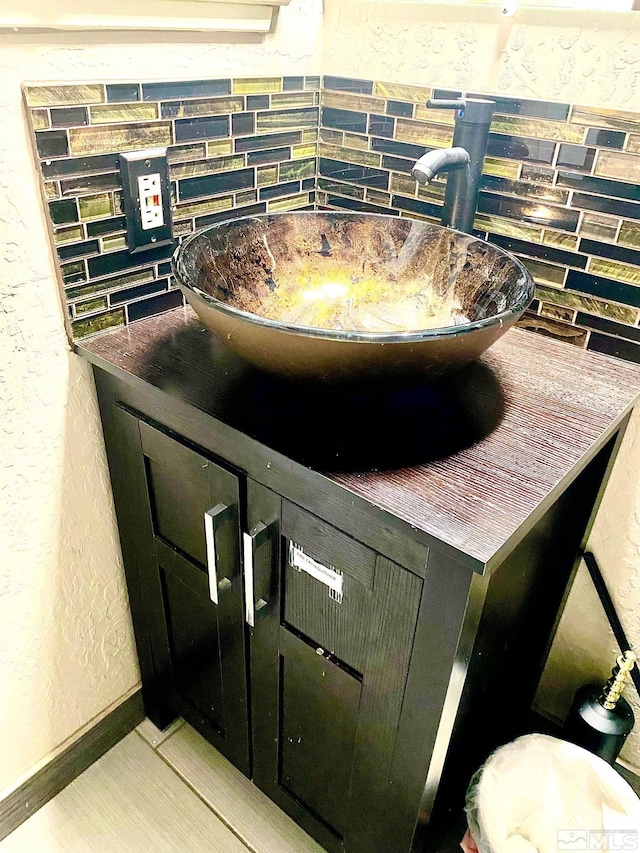 interior details featuring sink and tasteful backsplash