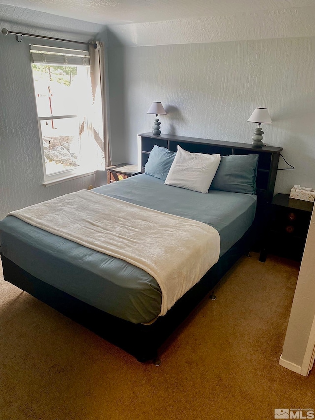 carpeted bedroom with a textured ceiling