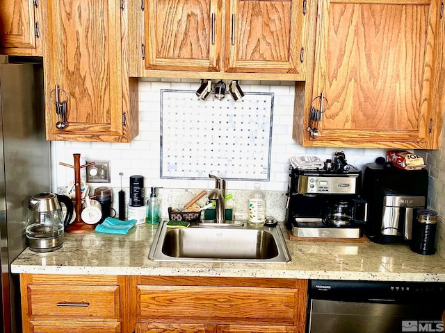 kitchen with stainless steel appliances, backsplash, and sink