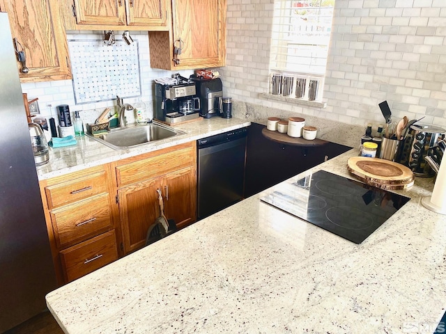 kitchen with decorative backsplash, appliances with stainless steel finishes, a healthy amount of sunlight, and sink