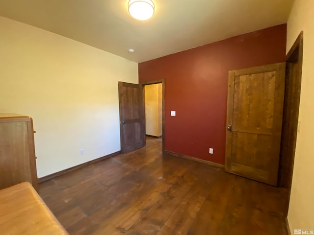 unfurnished bedroom featuring dark wood-type flooring