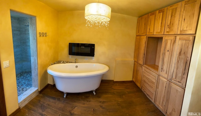 bathroom featuring a chandelier, plus walk in shower, and hardwood / wood-style flooring