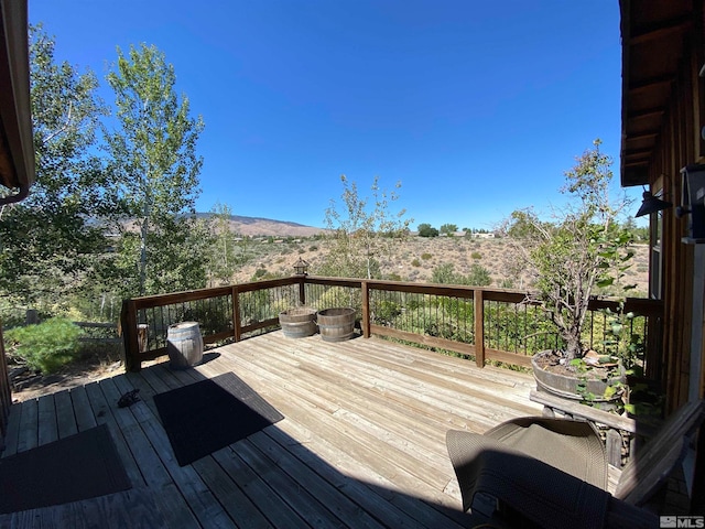 wooden deck with a mountain view