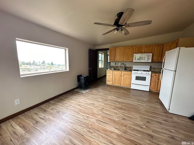 kitchen featuring white appliances, ceiling fan, vaulted ceiling, and light hardwood / wood-style floors