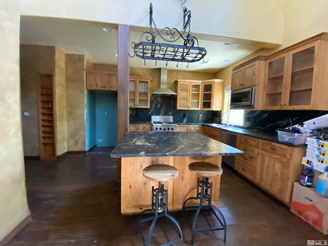 kitchen featuring black dishwasher, a center island, dark hardwood / wood-style floors, tasteful backsplash, and wall chimney exhaust hood