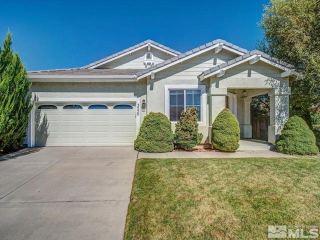 view of front of home featuring a garage and a front lawn