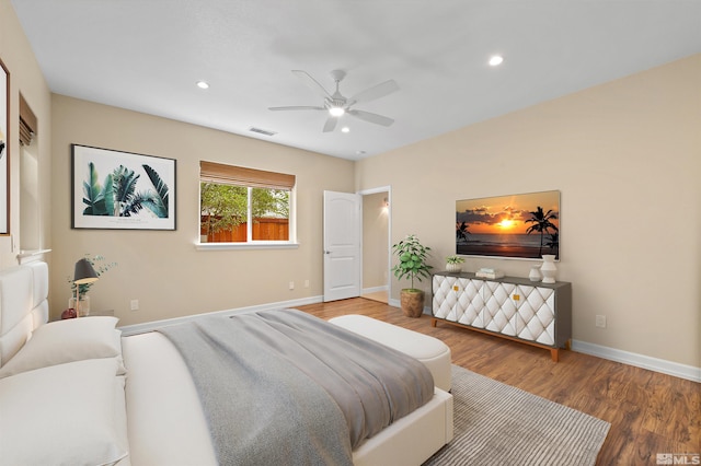 bedroom with ceiling fan and hardwood / wood-style flooring