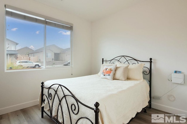 bedroom with wood-type flooring