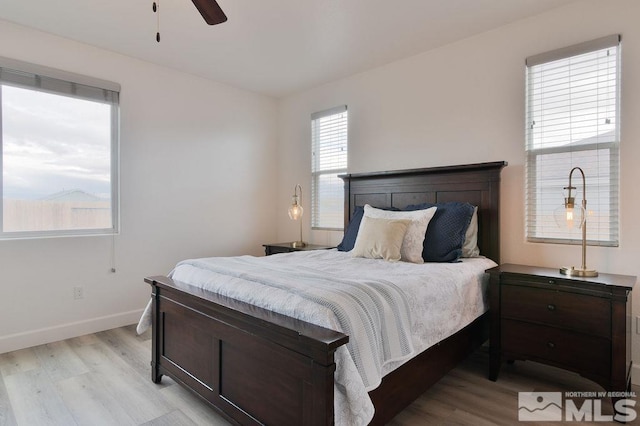 bedroom with light hardwood / wood-style floors and ceiling fan