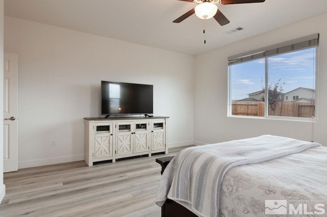 bedroom with light hardwood / wood-style flooring and ceiling fan