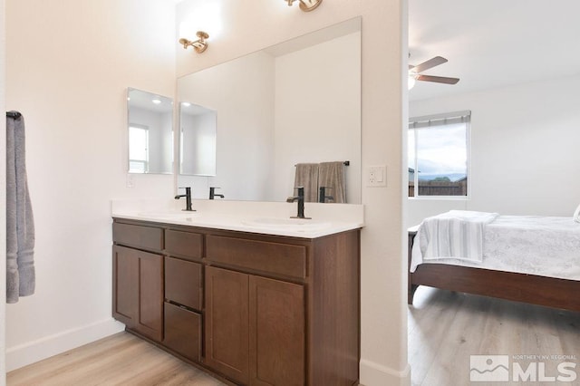 bathroom featuring ceiling fan, hardwood / wood-style flooring, and vanity