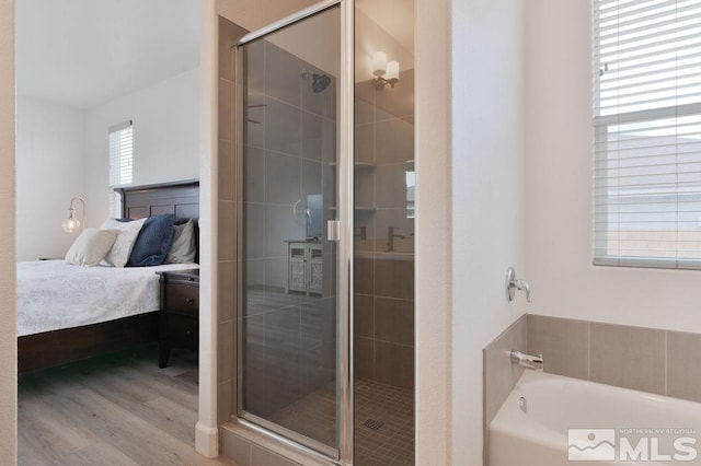 bathroom with independent shower and bath and hardwood / wood-style floors