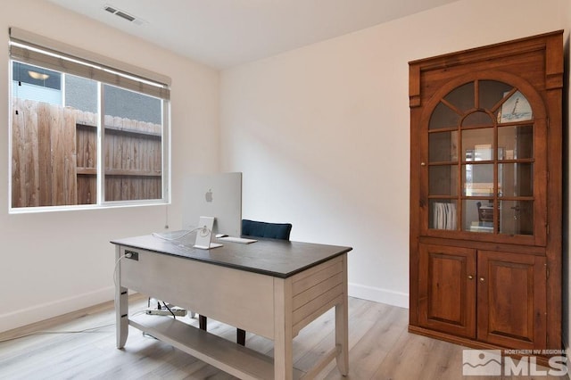 office with light hardwood / wood-style flooring