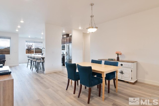 dining area with light wood-type flooring