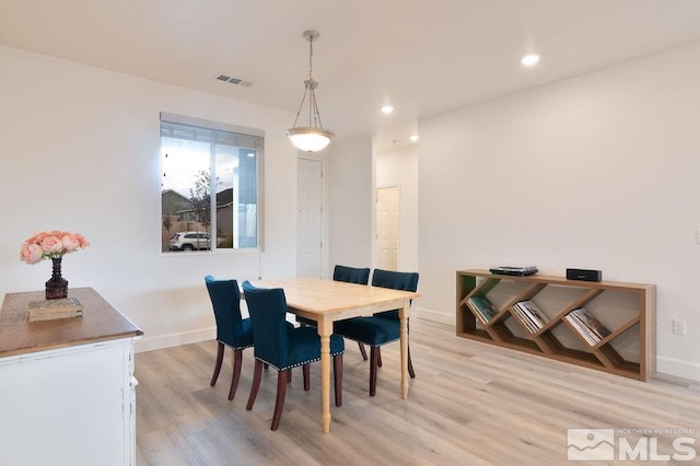 dining space with light wood-type flooring