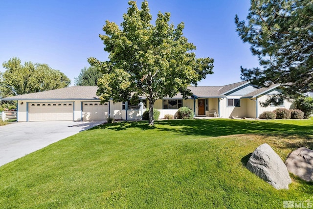 view of front of property with a garage and a front yard