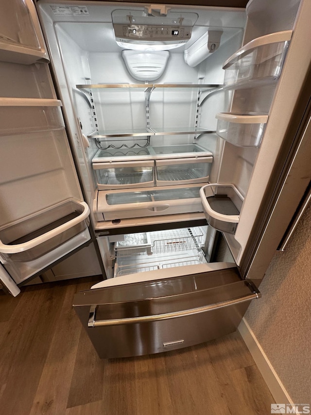 details featuring stainless steel refrigerator and dark hardwood / wood-style flooring