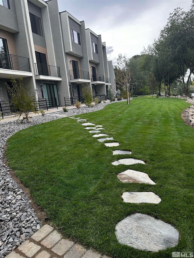 view of yard with a balcony