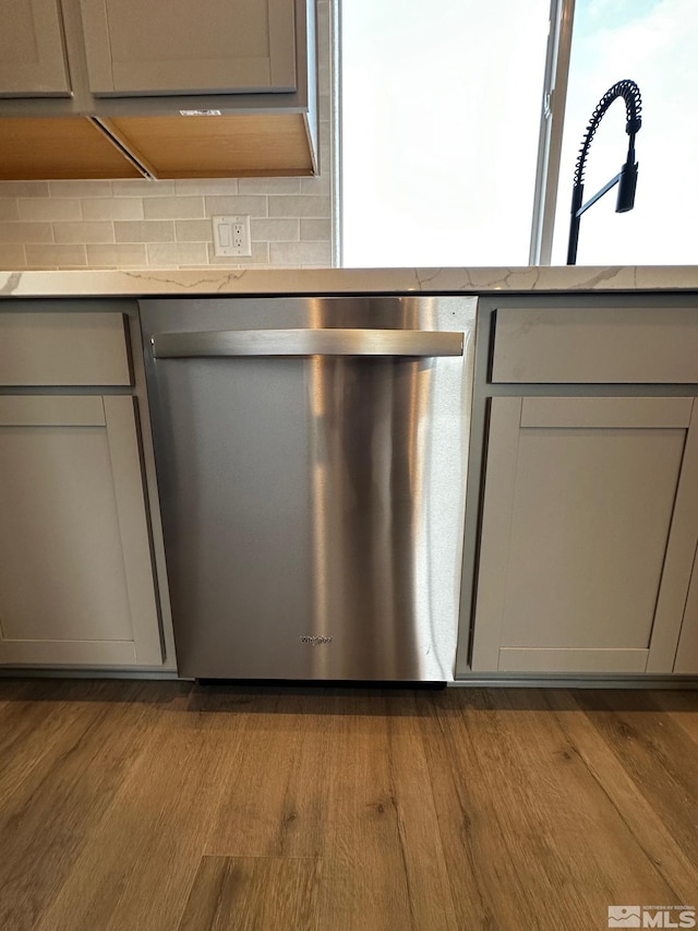 room details featuring gray cabinets, dishwasher, and light hardwood / wood-style floors