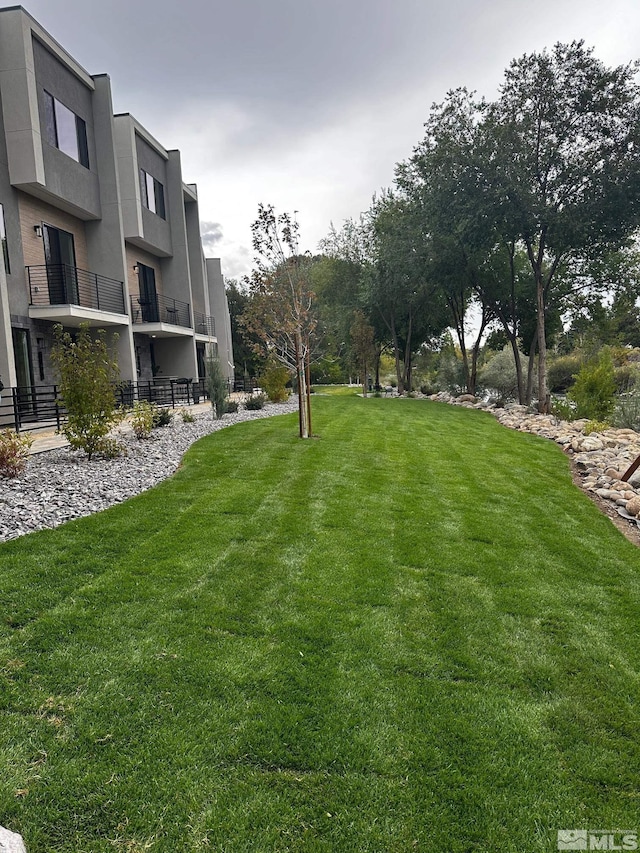 view of yard with a balcony