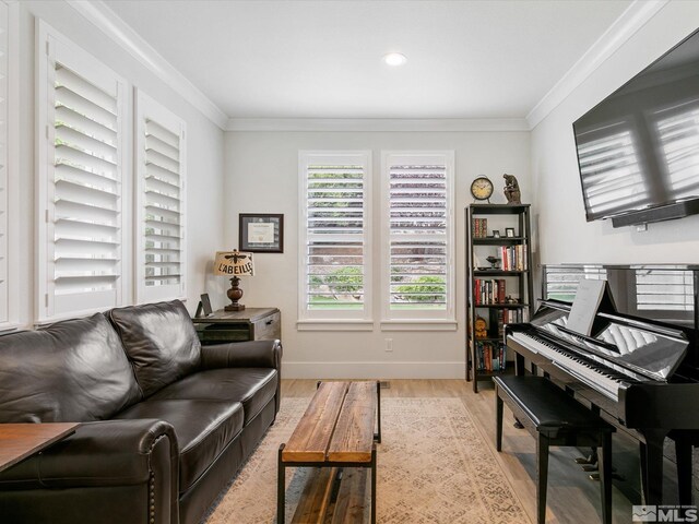 interior space featuring ornamental molding and light hardwood / wood-style floors