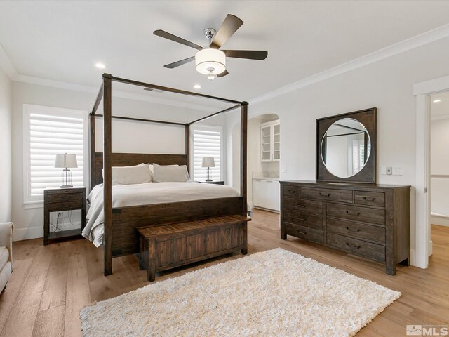 bedroom featuring ornamental molding, light hardwood / wood-style floors, and ceiling fan