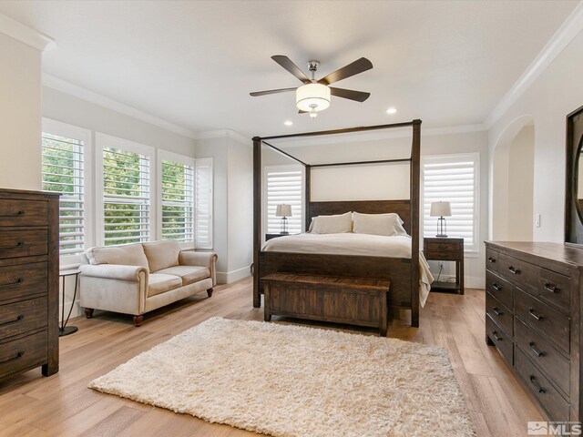 bedroom featuring ceiling fan, crown molding, and light hardwood / wood-style floors