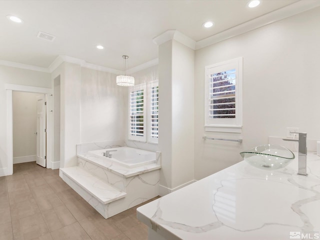 bathroom featuring a tub to relax in, crown molding, vanity, and a wealth of natural light