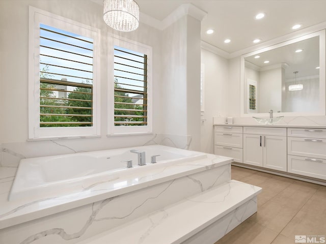 bathroom with tile patterned flooring, a notable chandelier, a tub, ornamental molding, and vanity