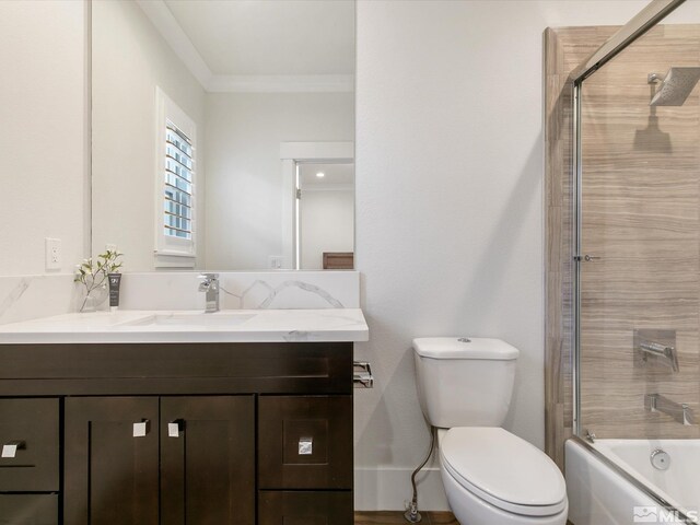 full bathroom with combined bath / shower with glass door, crown molding, vanity, and toilet