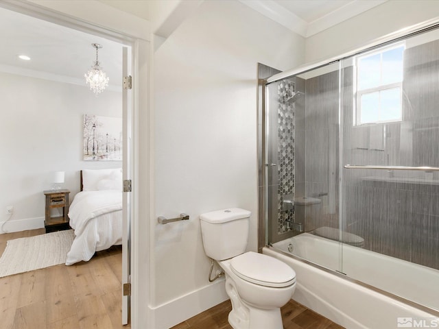 bathroom featuring ornamental molding, bath / shower combo with glass door, hardwood / wood-style floors, and toilet