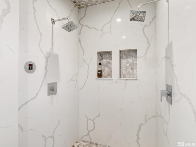 bathroom with a tile shower