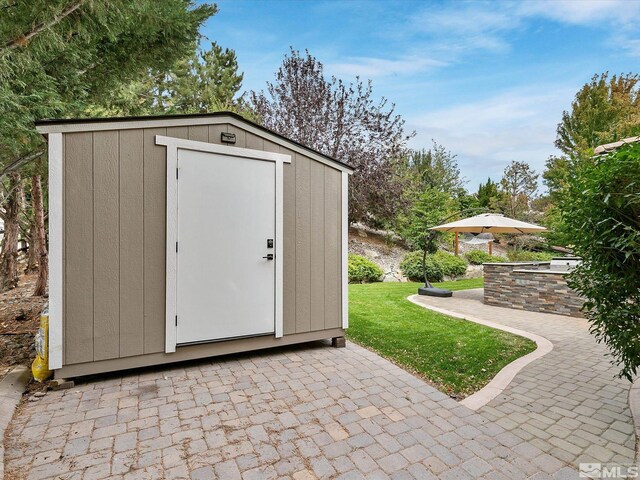 view of outbuilding featuring a lawn