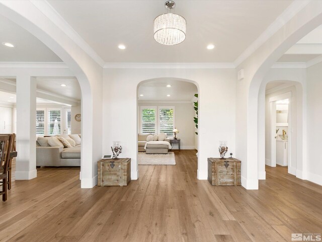 entryway featuring light wood-type flooring and ornamental molding