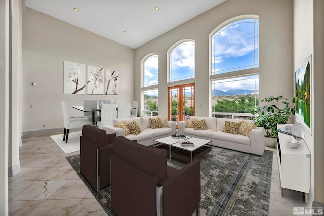 living room with a towering ceiling and a mountain view