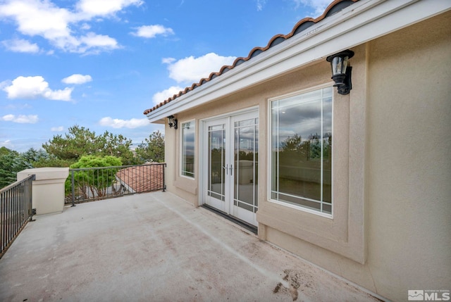 view of patio with a balcony and french doors