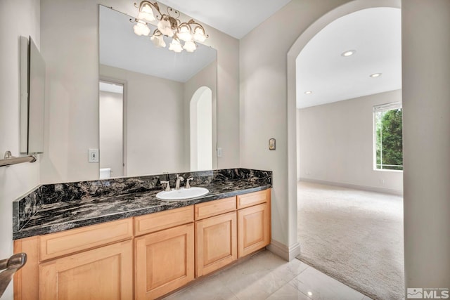 bathroom featuring vanity and a chandelier