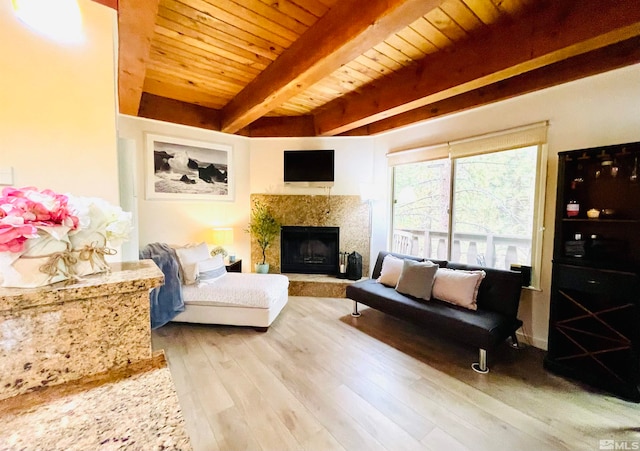 living room with light hardwood / wood-style flooring, beamed ceiling, and wooden ceiling